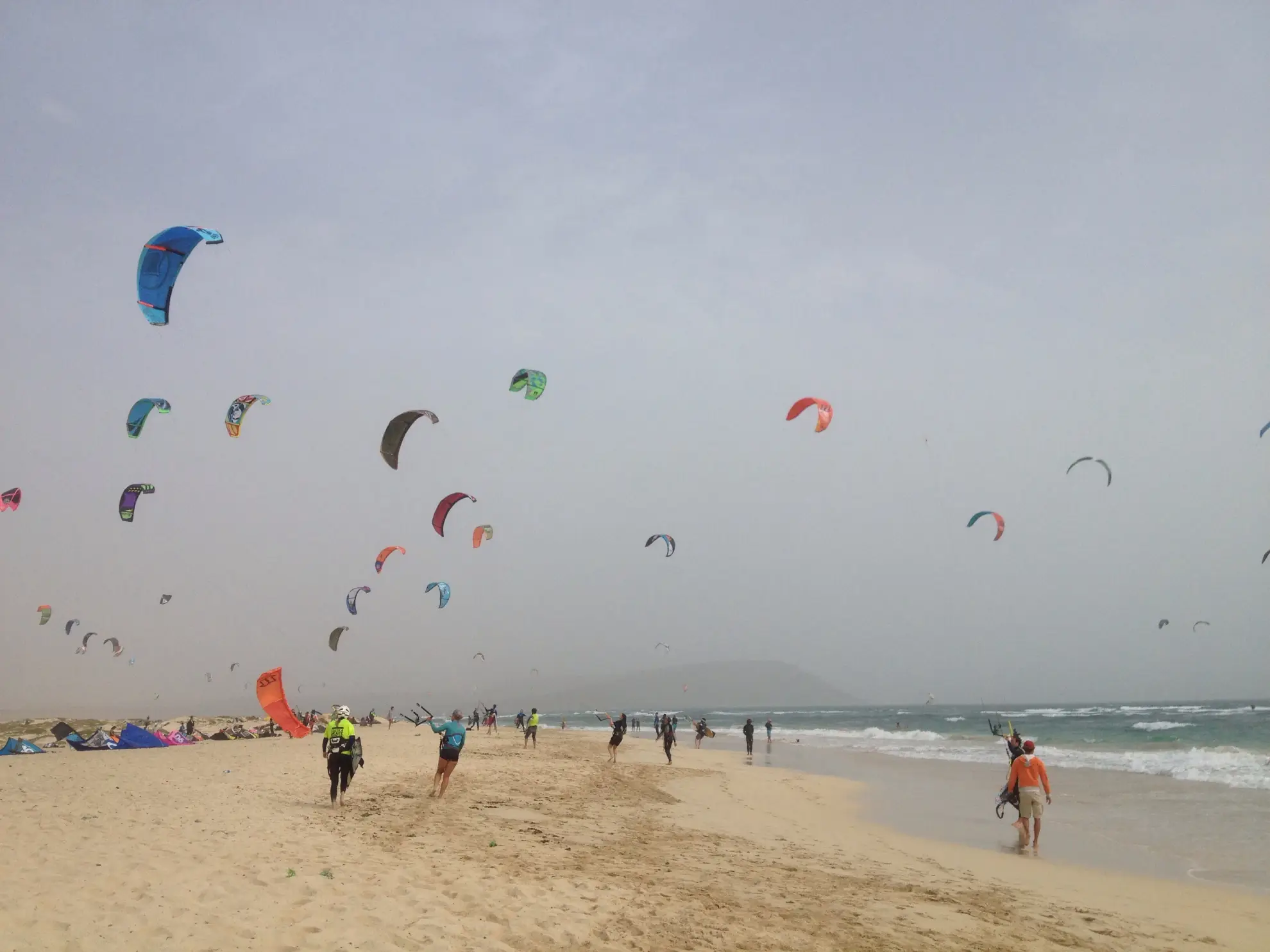 Kitesurfer airborne above the flat lagoon at Santa Maria Beach, Sal Island.