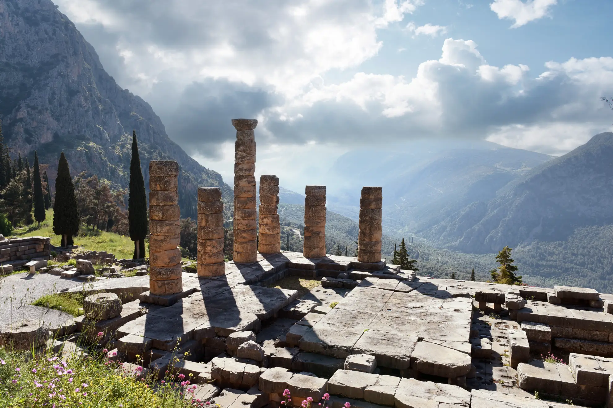 Expansive aerial view of Delphi archaeological site nestled on Mount Parnassus in central Greece.