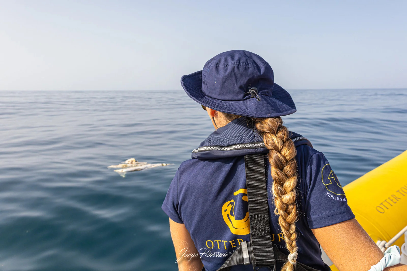 Marine biologist scanning Atlantic horizon for dolphins from Lagos tour boat