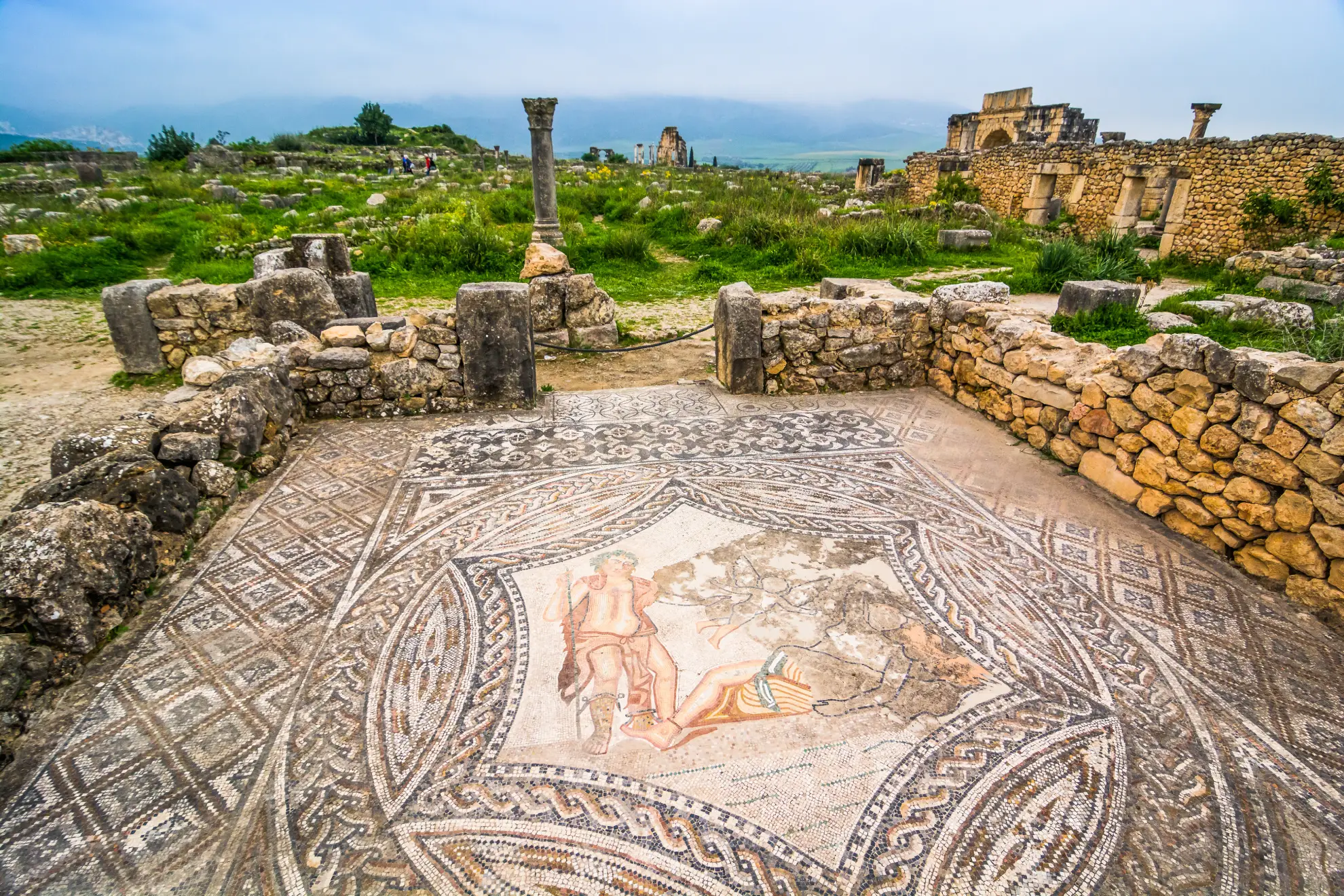 Preserved Roman mosaics and stonework at the Volubilis archaeological site.