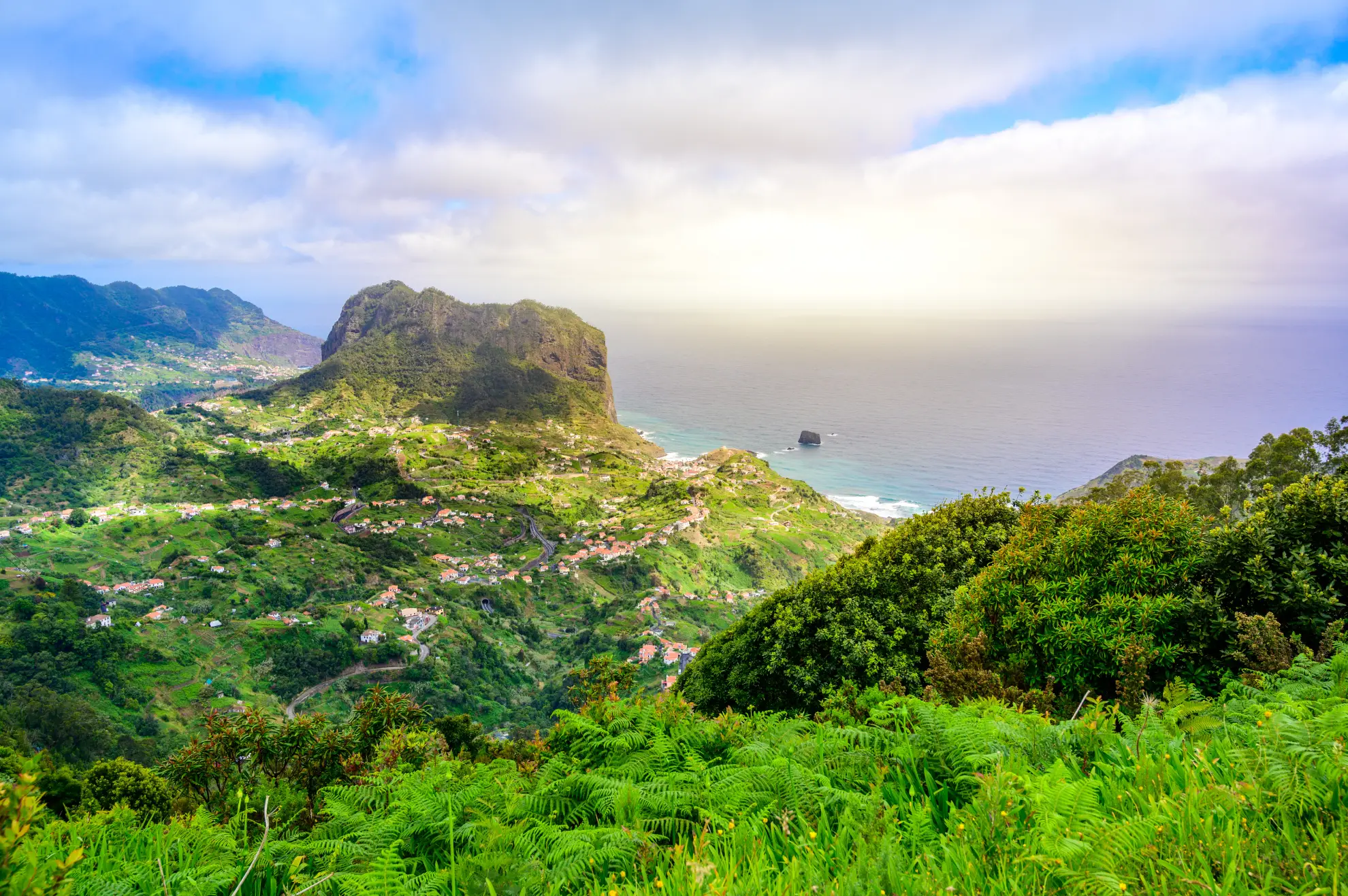 Panoramic view from Portela viewpoint toward Penha d'&Aacute;guia rock formation on Madeira's north coast.