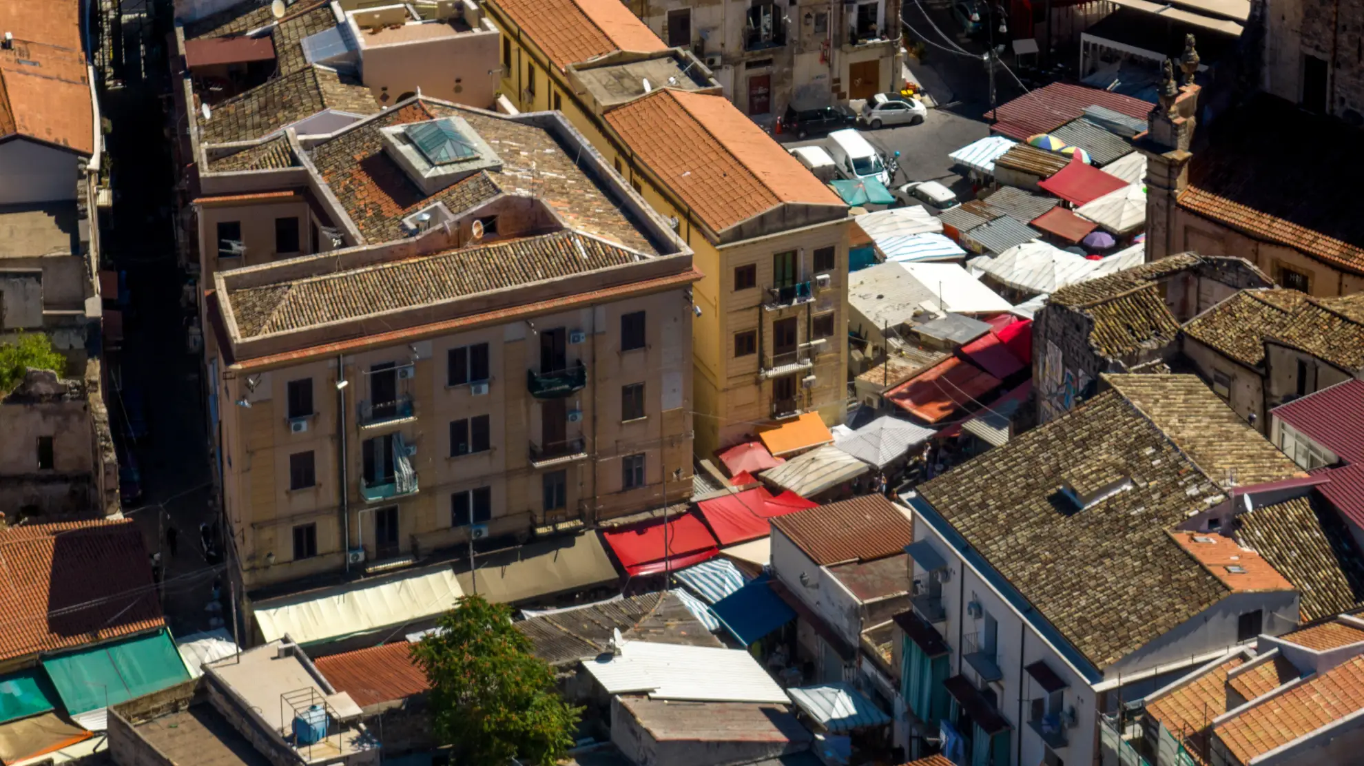 Aerial view of colorful Ballar&ograve; market stalls in Palermo's Albergheria district.