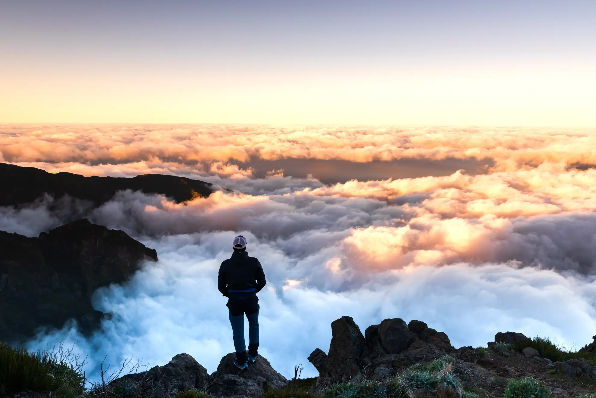 Pico Ruivo summit rising above cloud inversion at dawn in Madeira.