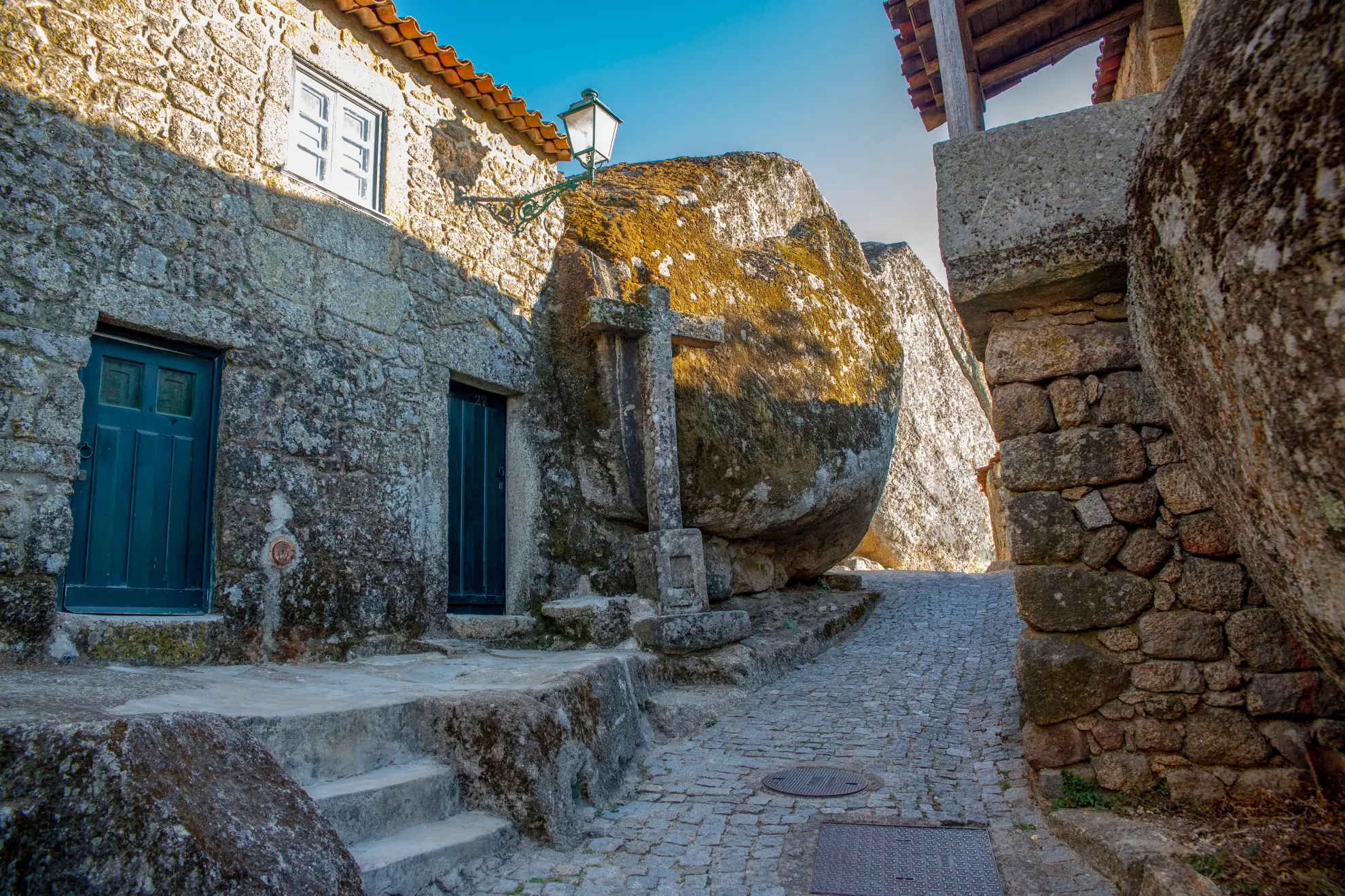 Stone lane in Monsanto village with granite boulders overhanging traditional houses