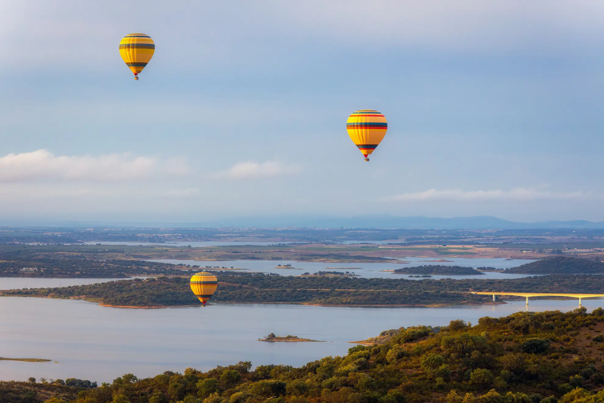 Hot air balloon at dawn above cork oak plains in the Alentejo region