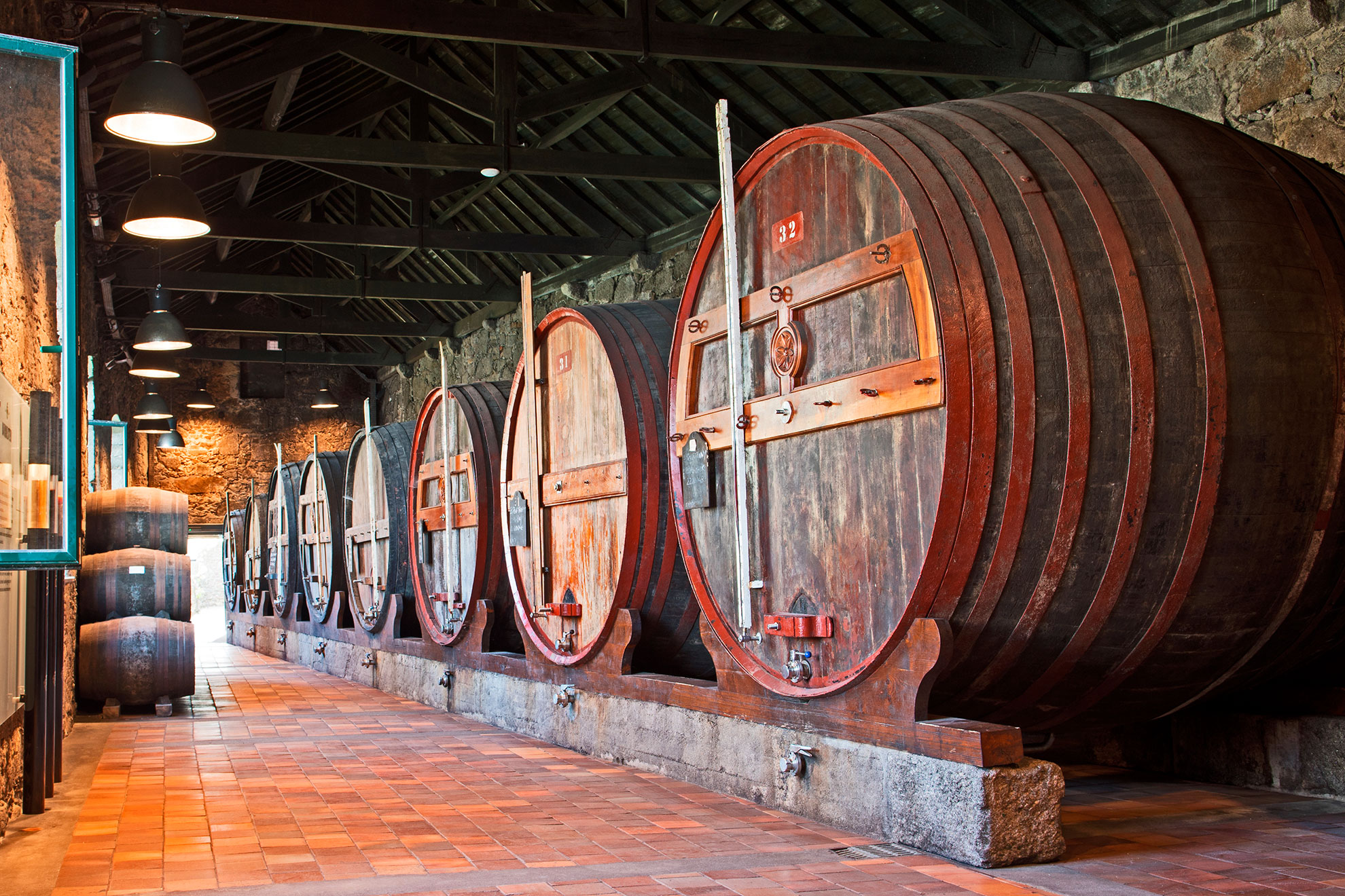 Rows of oak ageing casks in a Vila Nova de Gaia Port wine lodge