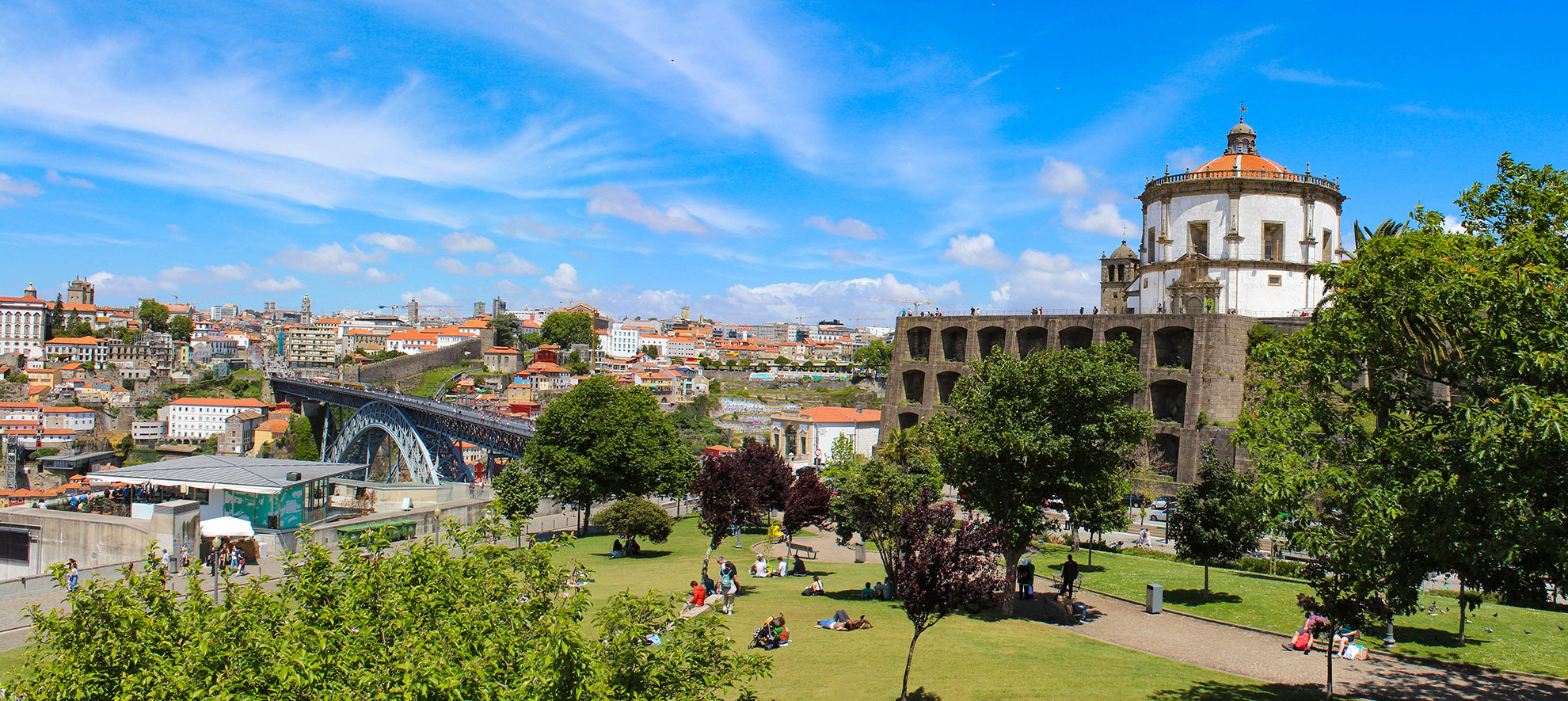 Porto Ribeira and Dom Lu&iacute;s I Bridge illuminated at dusk from Jardim do Morro