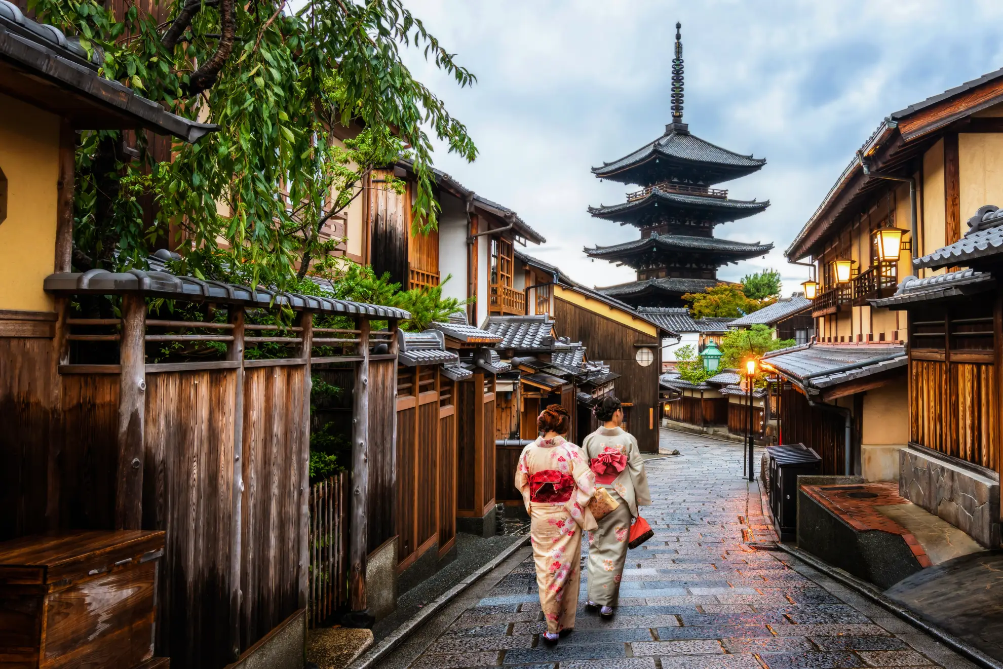 Traditional wooden machiya house in Gion district, Kyoto, lit by evening lanterns.