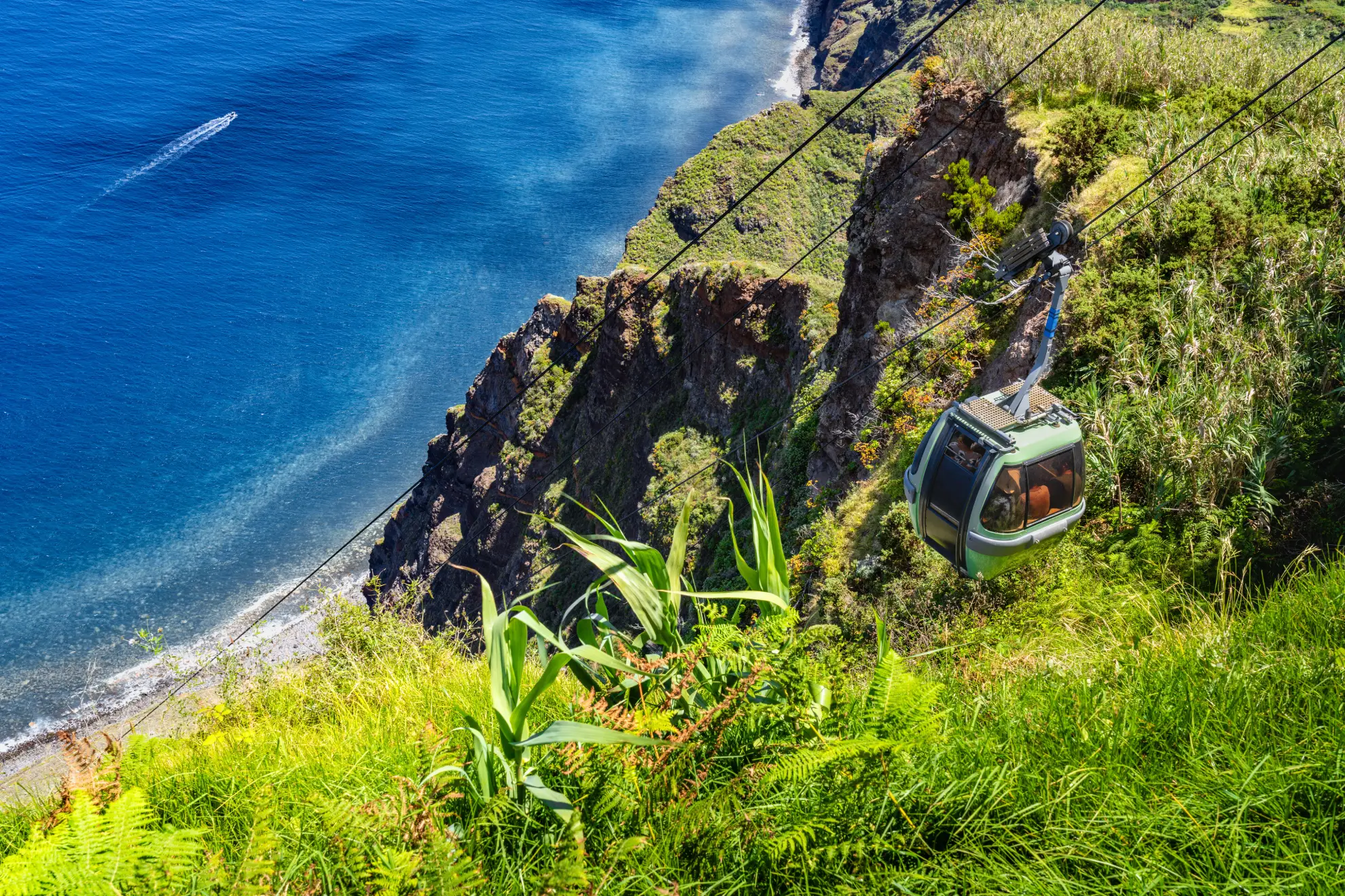 View from inside Achadas da Cruz cable car descending steep Madeira cliff