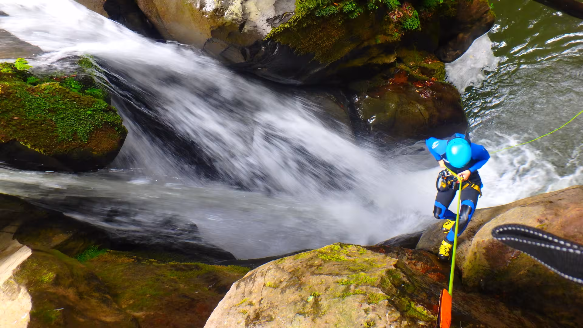 Canyoner descending a waterfall in the lush Salto do Cabrito canyon, São Miguel, Azores