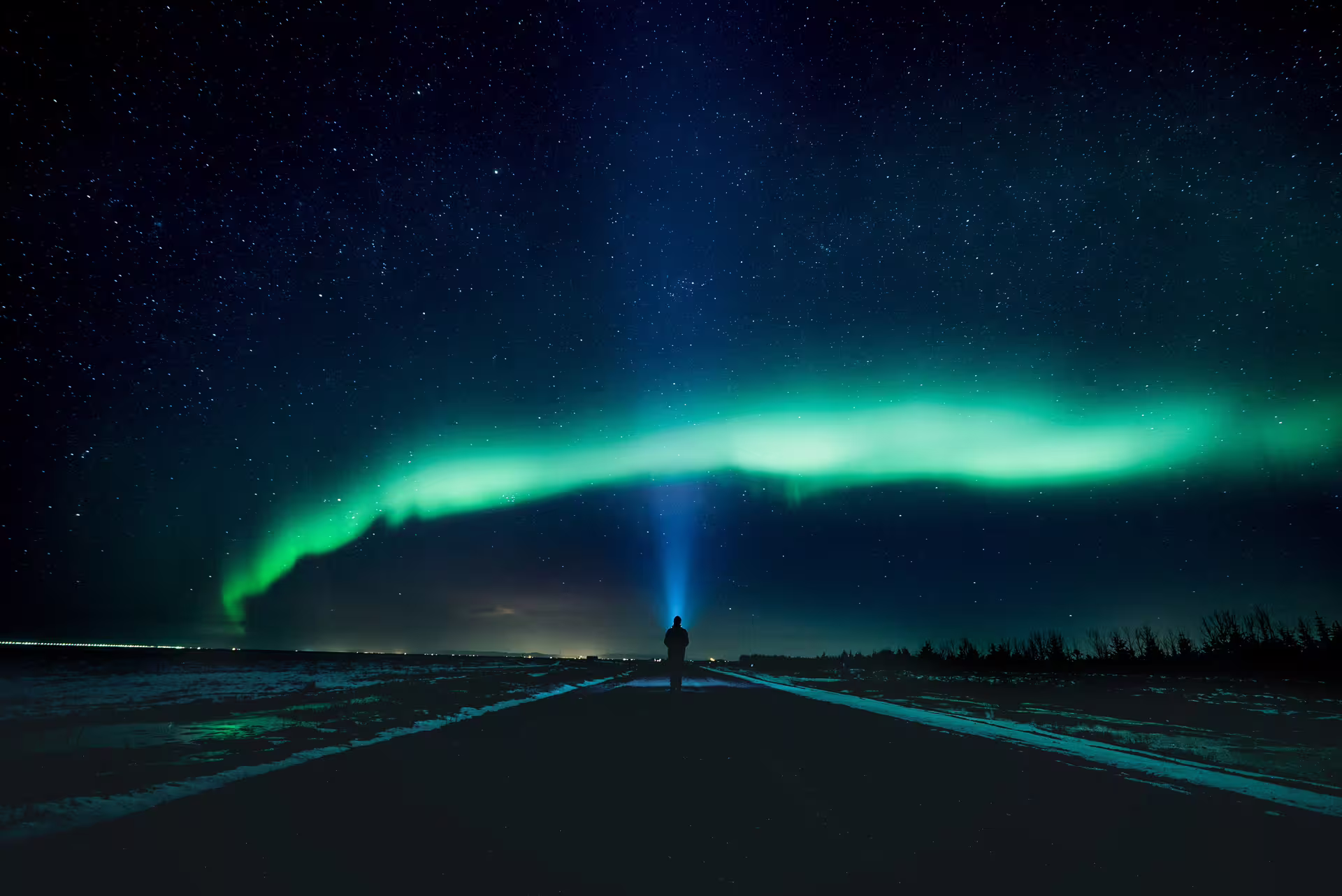 Northern lights minibus tour from Reykjavík — aurora borealis over the Icelandic countryside with hot chocolate at the viewing site